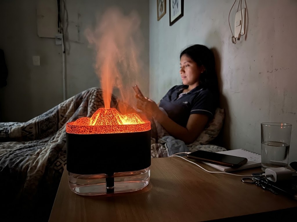 Humidificador volcán encendido con vapor sobre la mesa de noche